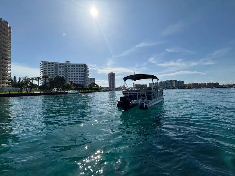 Slide: The Image of 2021 Godfrey Sweetwater pontoon boat on clear water with city skyline in background. - 5