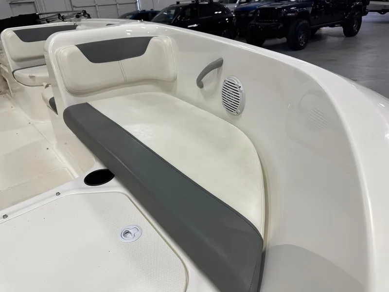 Slide: The Image of 2021 Bayliner Element E18 boat interior with cushioned seating and speaker. - 14