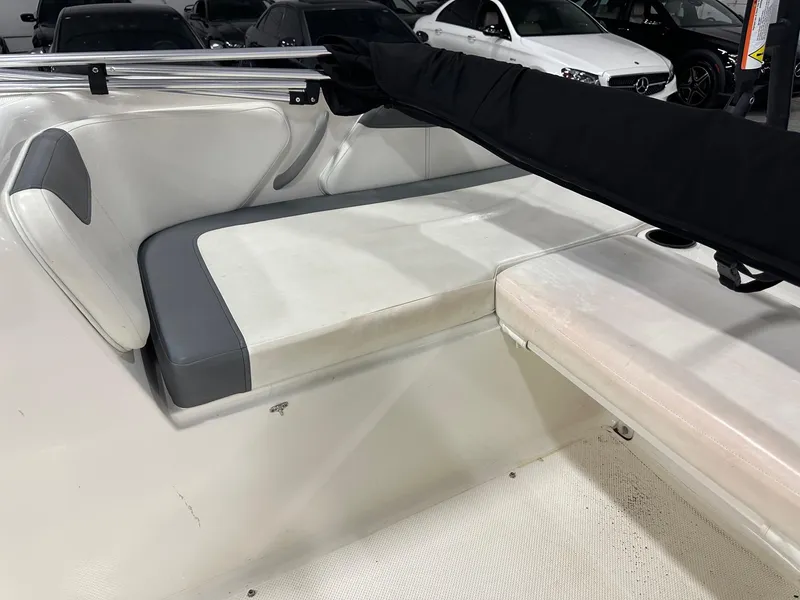 Slide: The Image of 2021 Bayliner Element E18 boat interior with white and gray seating. - 18