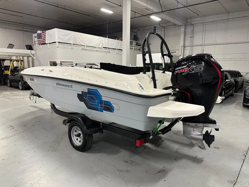 Slide: The Image of 2021 Bayliner Element E18 boat with Mercury Pro XS engine in a showroom. - 2
