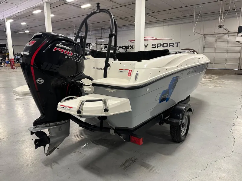 Slide: The Image of 2021 Bayliner Element E18 boat with Mercury Pro XS engine in a showroom. - 6