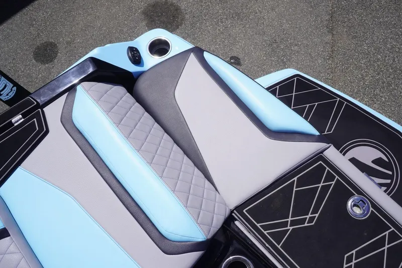 Slide: The Image of 2023 Tigé 23ZX boat interior with blue and gray cushioned seating. - 29