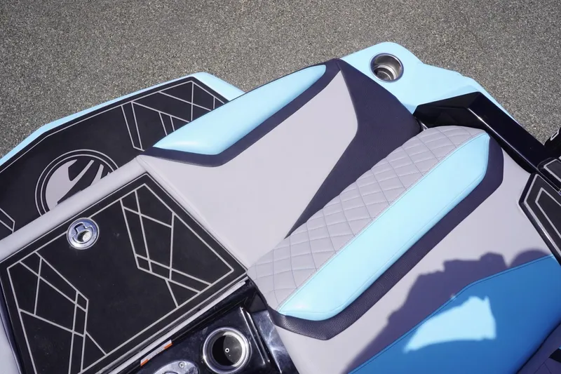 Slide: The Image of 2023 Tigé 23ZX boat interior with stylish blue and gray seating and geometric design. - 30
