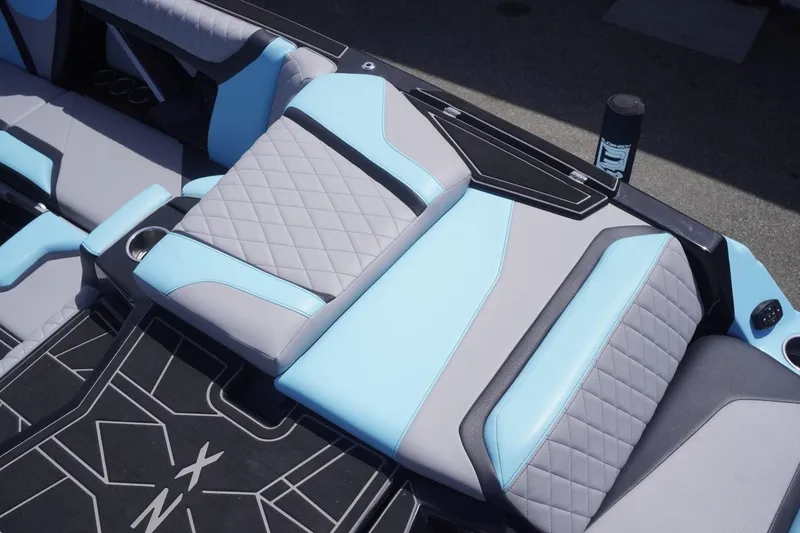 Slide: The Image of 2023 Tigé 23ZX boat interior with blue and gray quilted seating. - 31