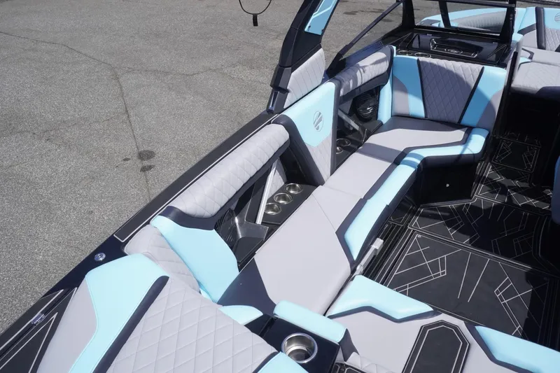 Slide: The Image of 2023 Tigé 23ZX boat interior with stylish blue and gray seating and modern design. - 33