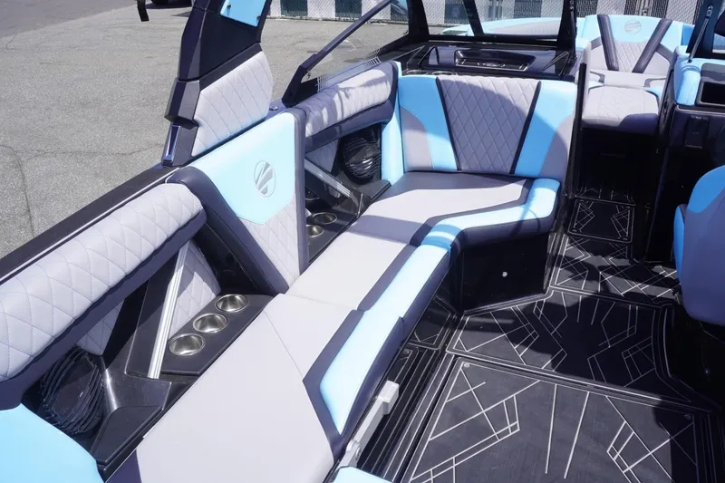 Slide: The Image of 2023 Tigé 23ZX boat interior with stylish blue and gray seating and geometric flooring. - 38
