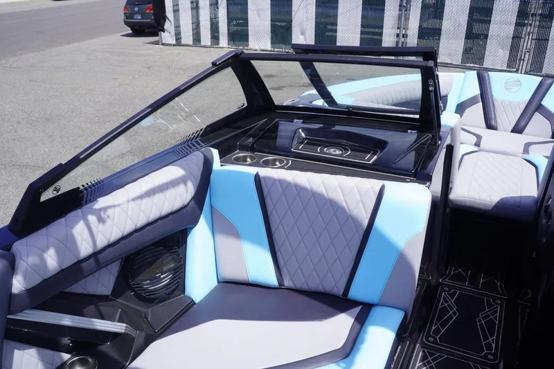 Slide: The Image of 2023 Tigé 23ZX boat interior with blue and gray seating, modern design. - 41