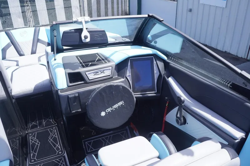 Slide: The Image of Interior of 2023 Tigé 23ZX boat with modern dashboard and steering wheel. - 43