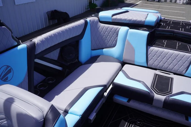 Slide: The Image of 2023 Tigé 23ZX boat interior with blue and gray quilted seating. - 46