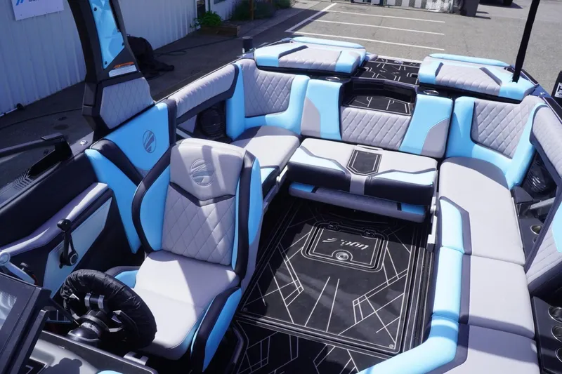 Slide: The Image of 2023 Tigé 23ZX boat interior with blue and gray seating, modern design. - 48