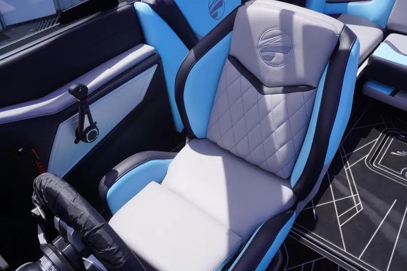 Slide: The Image of 2023 Tigé 23ZX boat interior with blue and gray seating, featuring modern design. - 49