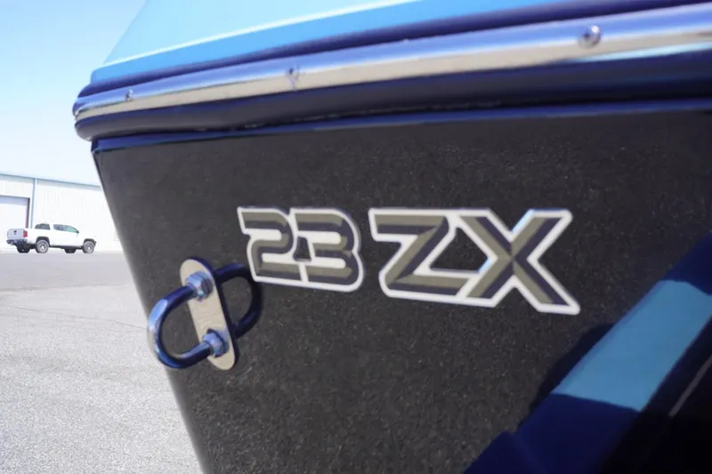 Slide: The Image of 2023 Tigé 23ZX boat close-up, showcasing model name on hull. - 7