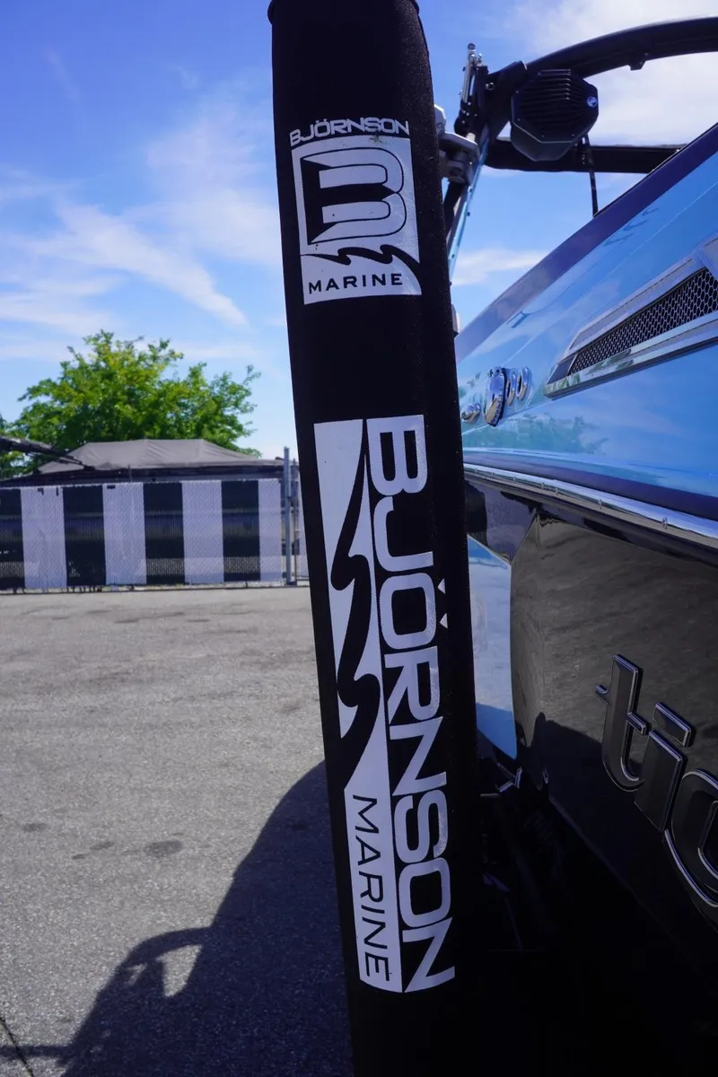 Slide: The Image of 2023 Tigé 23ZX boat with Bjornson Marine branding, parked outdoors under a clear sky. - 8