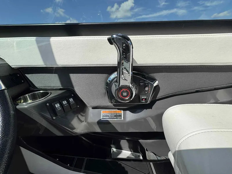 Slide: The Image of Control panel of 2023 Monterey 275SS boat with throttle lever and switches. - 13