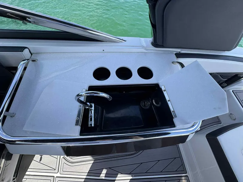Slide: The Image of 2023 Monterey 275SS boat sink with faucet and cup holders on deck. - 14