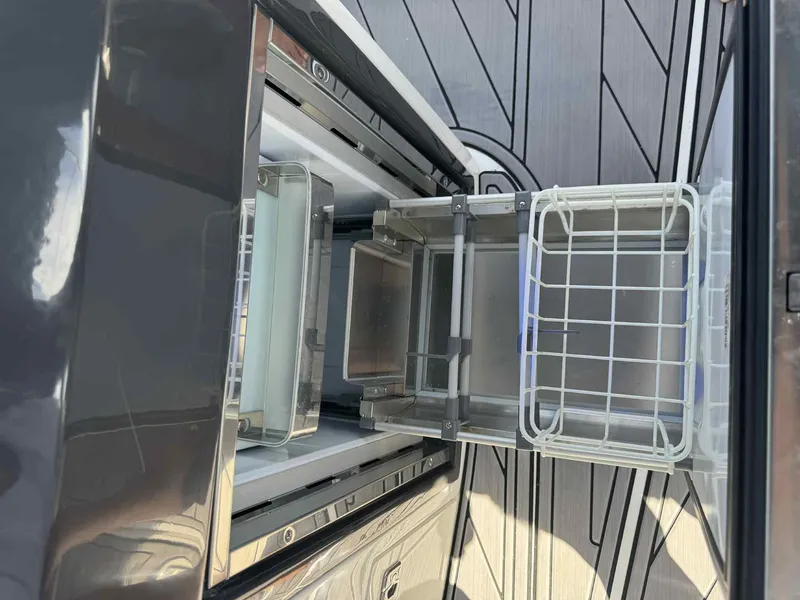 Slide: The Image of Open storage compartments on a 2023 Monterey 275SS boat deck. - 16