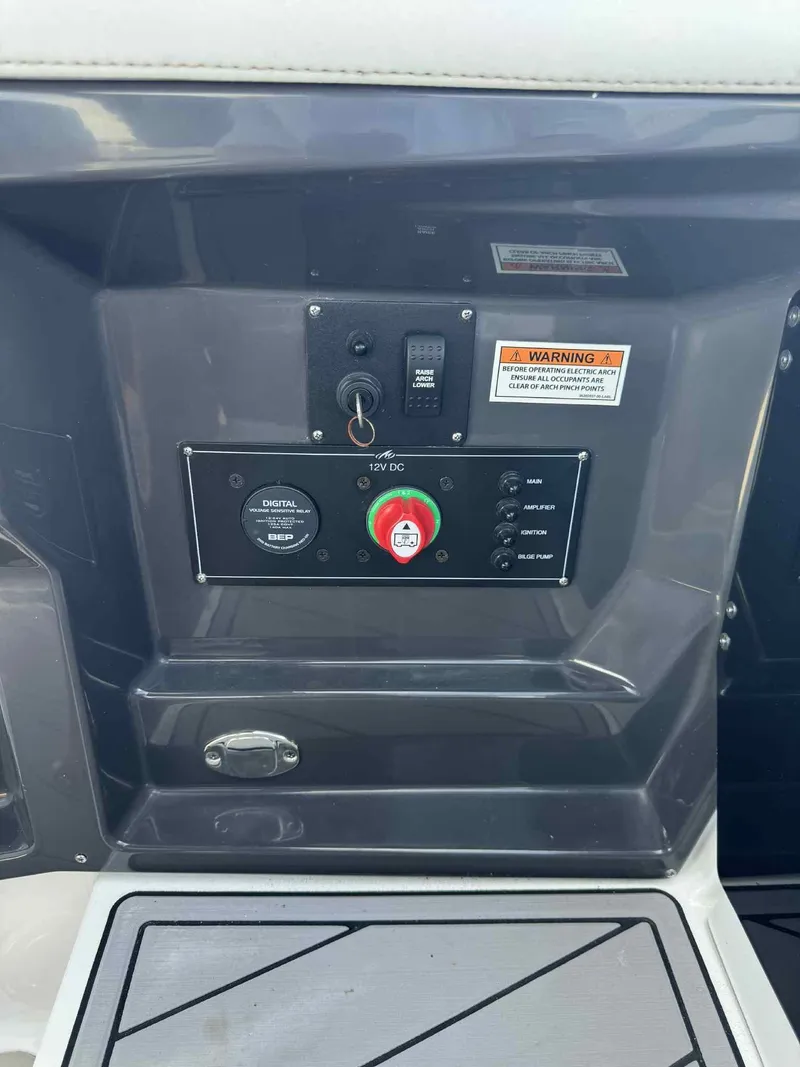 Slide: The Image of Control panel of 2023 Monterey 275SS boat with switches and warning label. - 19