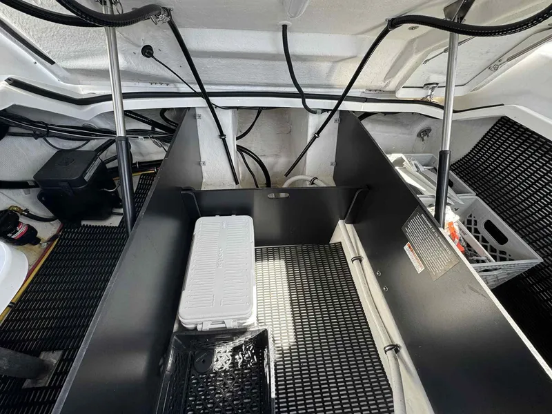 Slide: The Image of 2023 Monterey 275SS boat storage compartment with organized cables and equipment. - 25