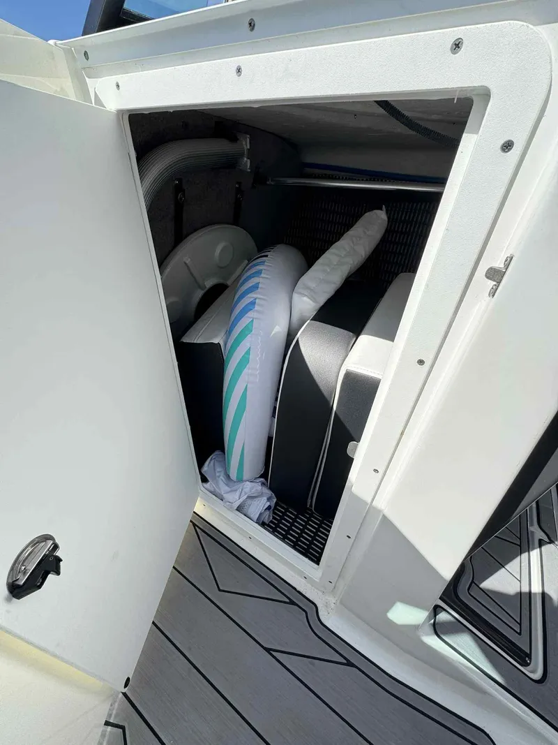 Slide: The Image of Storage compartment in 2023 Monterey 275SS boat with surfboard and equipment. - 27
