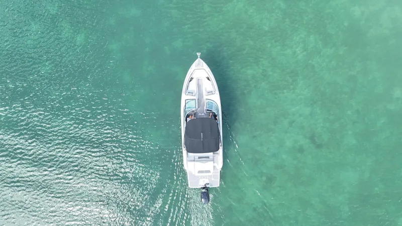 Slide: The Image of Aerial view of 2023 Monterey 275SS boat on clear turquoise water. - 3
