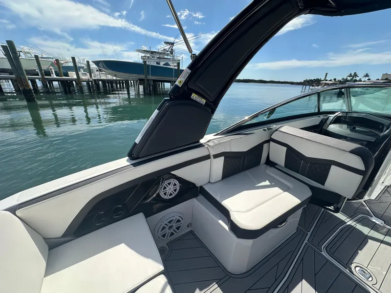 Slide: The Image of 2023 Monterey 275SS boat interior with sleek seating and waterfront view. - 5