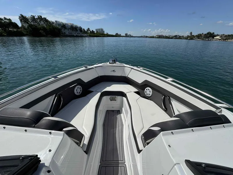 Slide: The Image of 2023 Monterey 275SS boat interior with sleek seating on a calm waterway. - 7