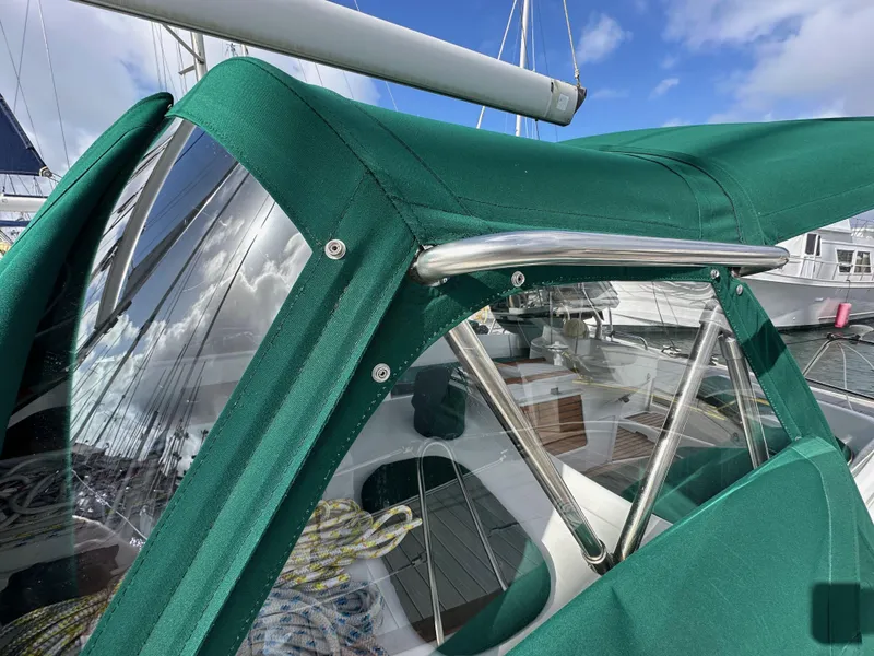 Slide: The Image of Green canopy on a 2002 Beneteau 411 sailboat, showcasing cockpit details and clear windows. - 10