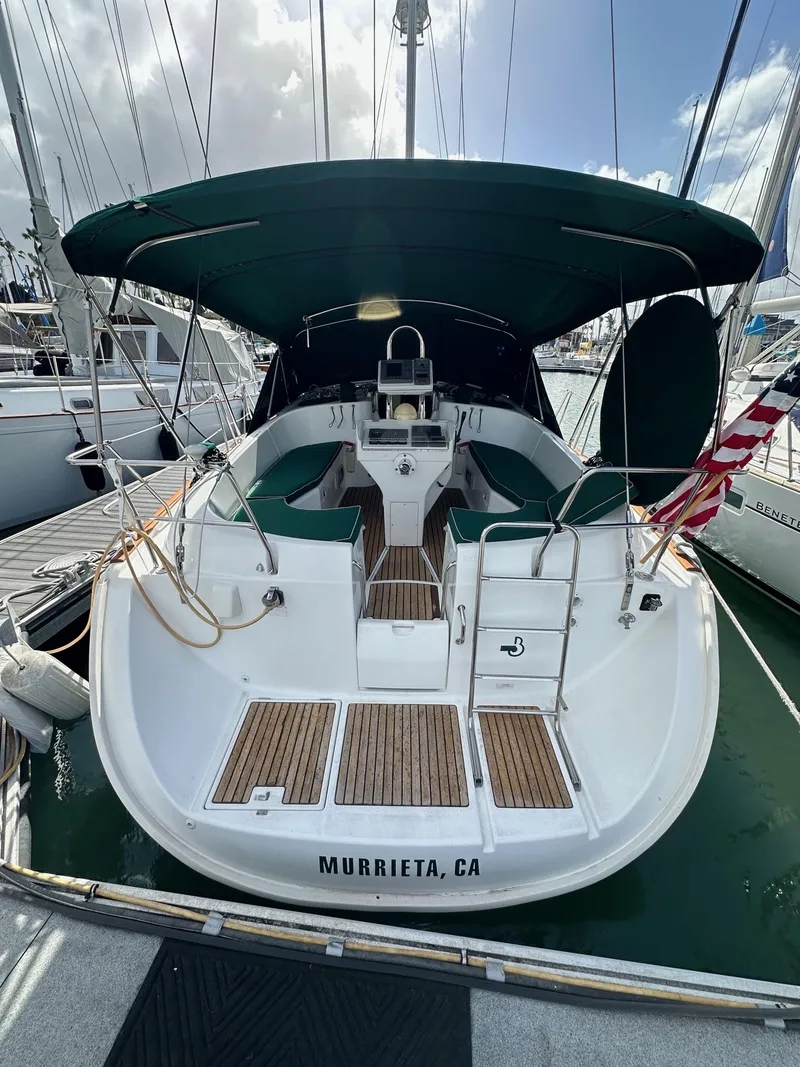 Slide: The Image of 2002 Beneteau 411 sailboat docked in Murrieta, CA, with green canopy and wooden deck. - 12