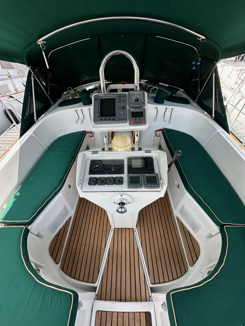 Slide: The Image of 2002 Beneteau 411 yacht cockpit with green seating and navigation equipment. - 15