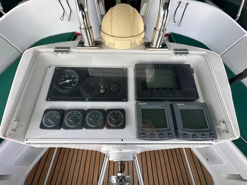 Slide: The Image of Control panel of a 2002 Beneteau 411 sailboat with navigation instruments. - 16