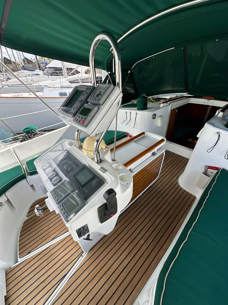Slide: The Image of 2002 Beneteau 411 yacht cockpit with navigation instruments and teak flooring. - 18