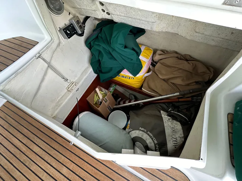 Slide: The Image of Storage compartment of a 2002 Beneteau 411 sailboat with various items and equipment. - 21