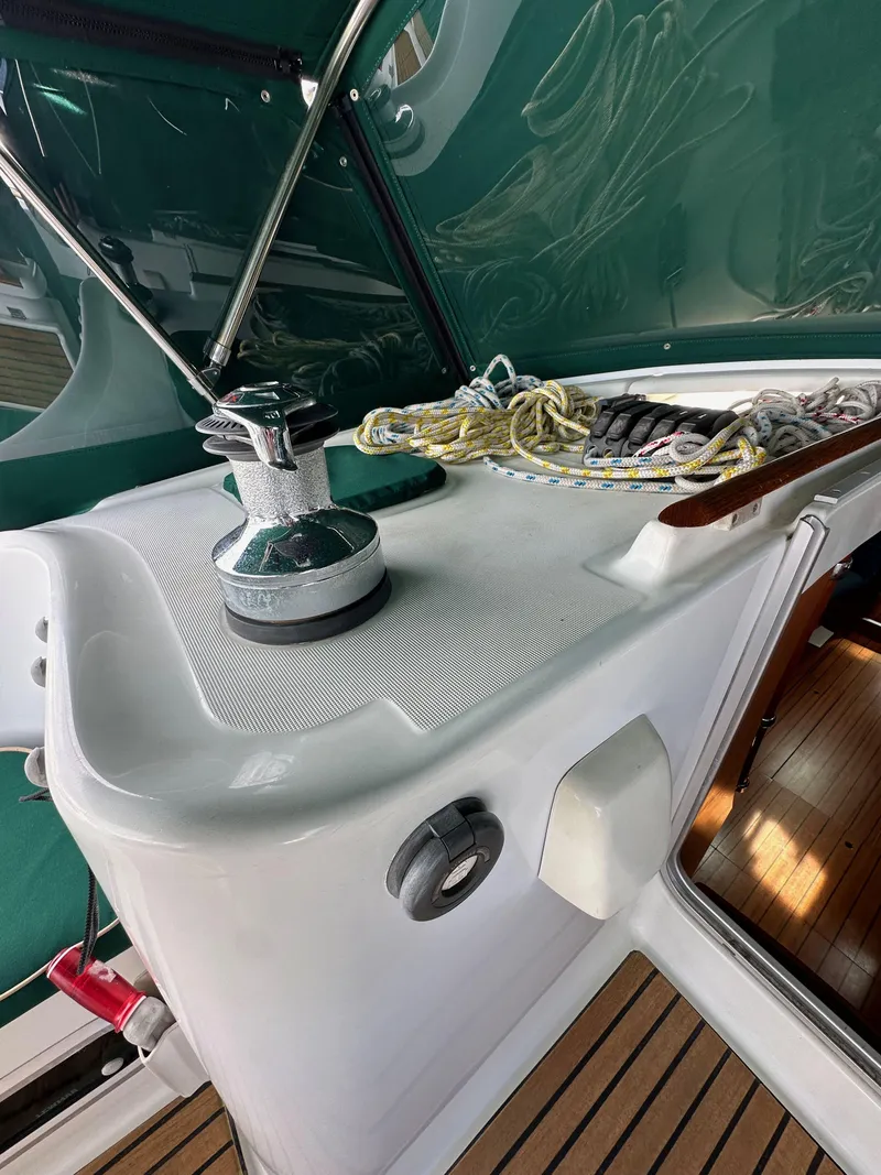 Slide: The Image of Beneteau 411 sailboat deck, featuring winch and ropes, 2002 model. - 24