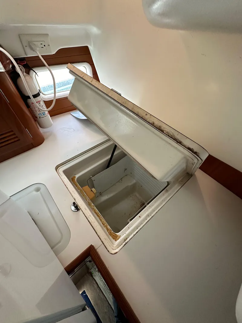 Slide: The Image of Open storage compartment in 2002 Beneteau 411 sailboat interior. - 34