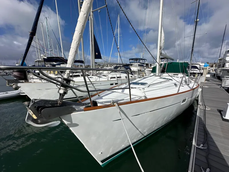 Slide: The Image of 2002 Beneteau 411 sailboat docked in marina under cloudy sky. - 4
