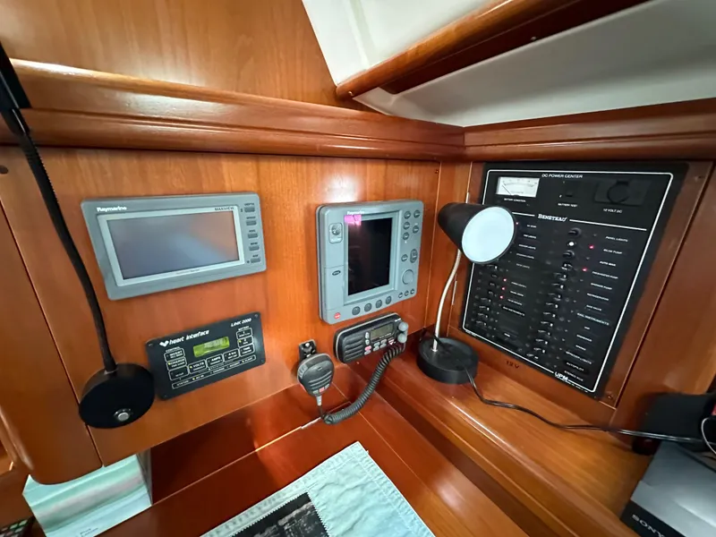 Slide: The Image of Control panel of a 2002 Beneteau 411 yacht with navigation and communication equipment. - 48