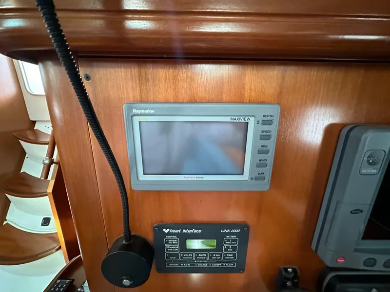 Slide: The Image of Navigation equipment on 2002 Beneteau 411 yacht, featuring Raymarine display and marine radio. - 49