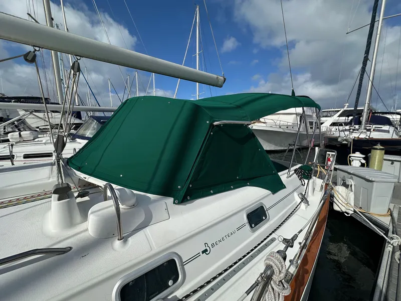 Slide: The Image of 2002 Beneteau 411 sailboat with green canopy docked at marina. - 9