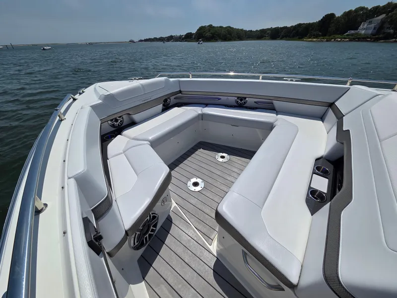 Slide: The Image of 2021 Formula 380 Super Sport Crossover OB boat interior with spacious seating on a sunny day. - 12
