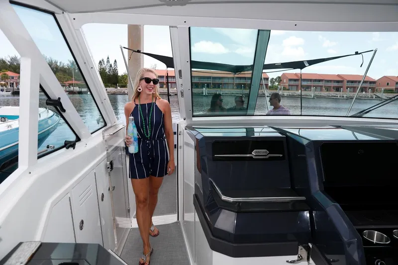 Slide: The Image of Manufacturer Provided Image: Woman aboard 2021 Formula 380 Super Sport Crossover OB yacht, enjoying a sunny day. - 13