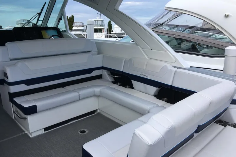 Slide: The Image of Manufacturer Provided Image: 2021 Formula 380 Super Sport Crossover OB interior seating area with white and blue upholstery. - 14