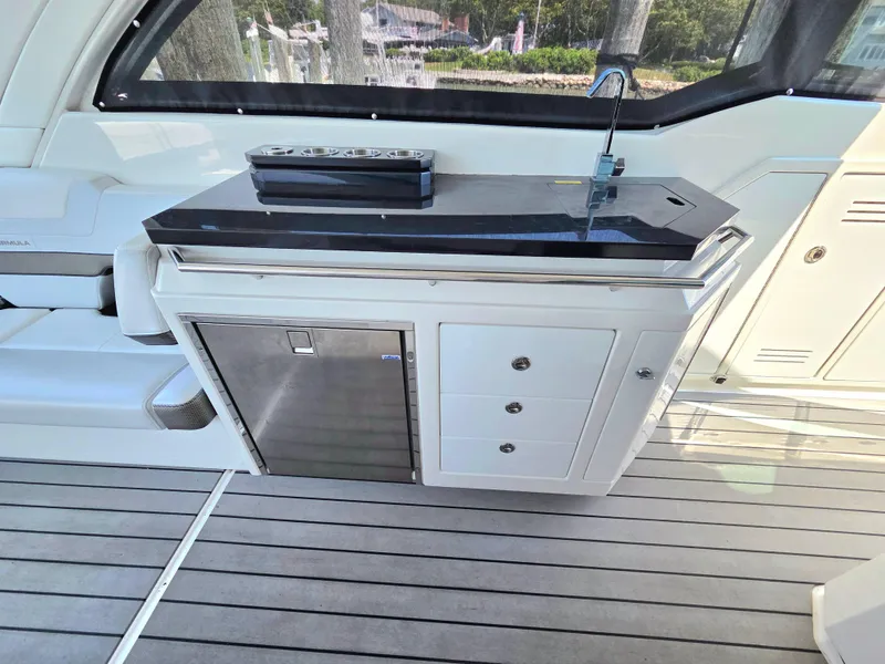Slide: The Image of 2021 Formula 380 Super Sport Crossover OB yacht interior with sleek kitchenette and modern design. - 18