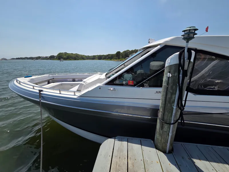 Slide: The Image of 2021 Formula 380 Super Sport Crossover OB docked by a scenic waterfront. - 2