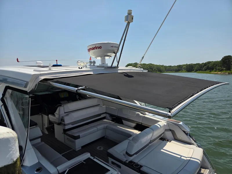 Slide: The Image of 2021 Formula 380 Super Sport Crossover OB with sunshade on a serene lake. - 24