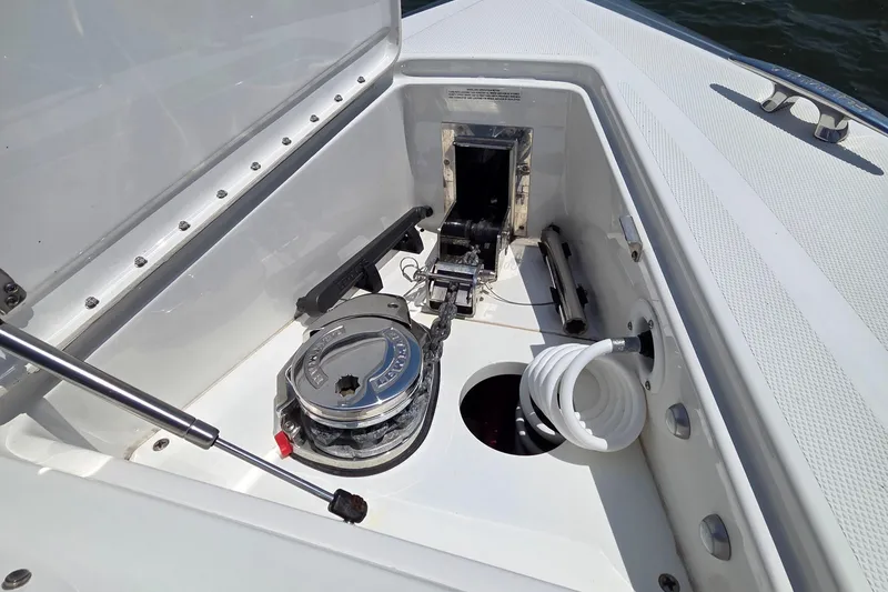 Slide: The Image of 2021 Formula 380 Super Sport Crossover OB anchor locker with winch and coiled hose. - 25