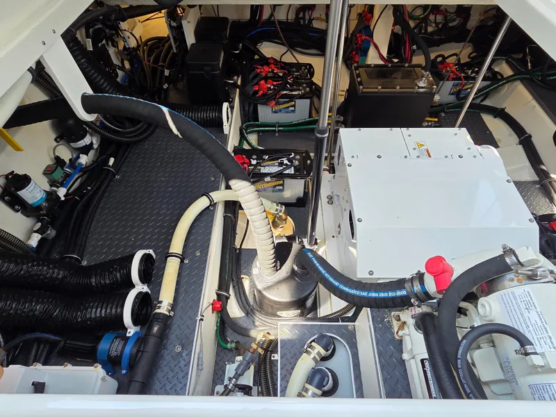 Slide: The Image of Engine compartment of a 2021 Formula 380 Super Sport Crossover OB, showcasing hoses and components. - 27