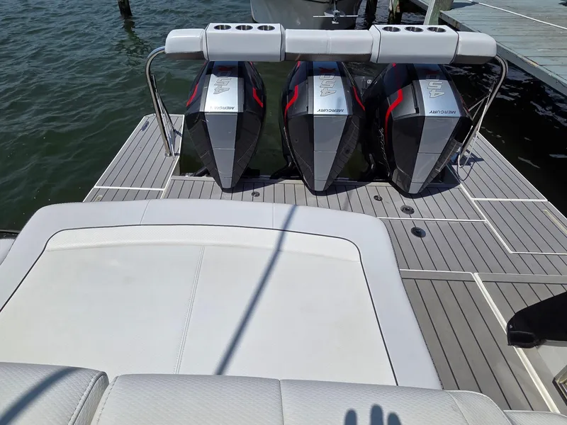 Slide: The Image of 2021 Formula 380 Super Sport Crossover OB with triple Mercury outboard engines on a dock. - 5
