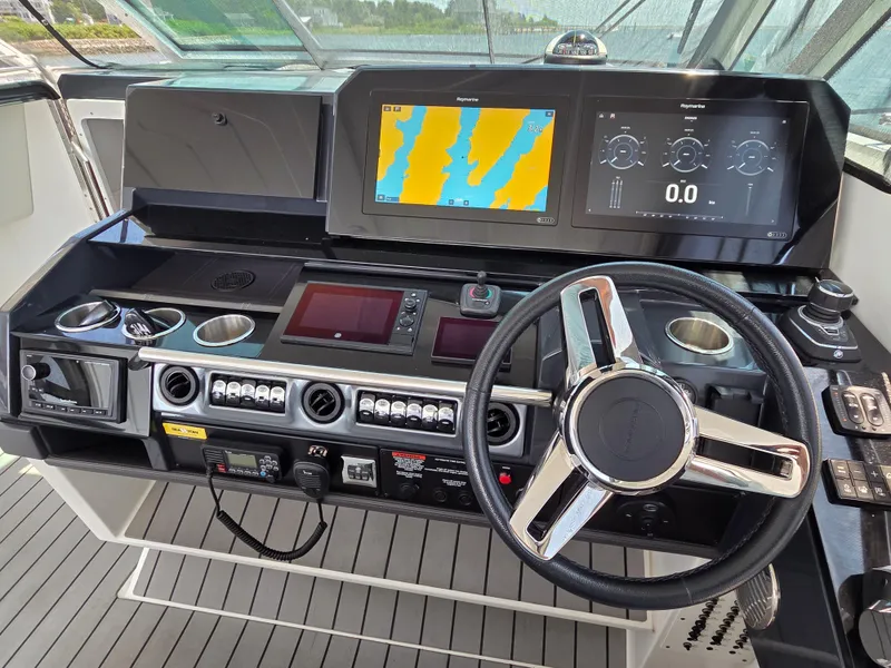Slide: The Image of Control panel of 2021 Formula 380 Super Sport Crossover OB with navigation screens and steering wheel. - 6