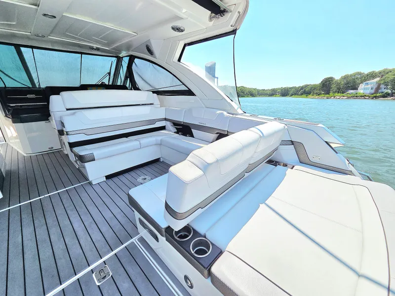Slide: The Image of 2021 Formula 380 Super Sport Crossover OB interior with luxurious seating and scenic water view. - 9