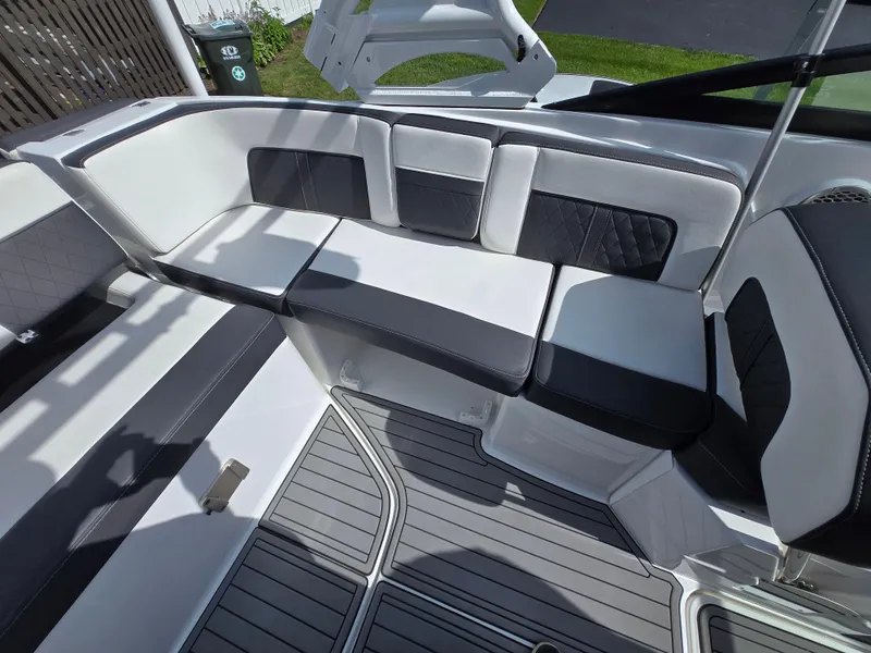 Slide: The Image of 2021 Monterey M-65 boat interior with sleek black and white seating and modern design. - 10